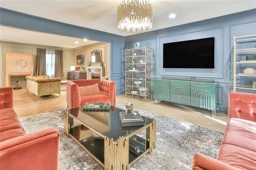 Living room with a decorative wall, a chandelier, recessed lighting, and crown molding Living room with a decorative wall, a chandelier, recessed lighting, and crown molding