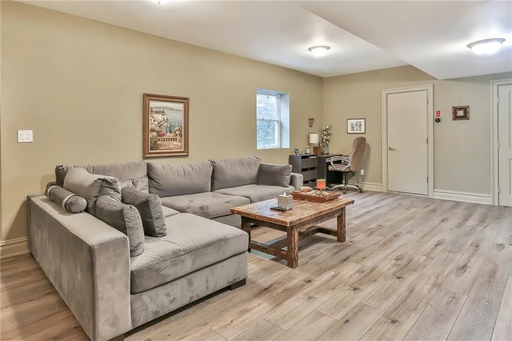 Lower level living room featuring light wood-style floors and a desk Lower level living room featuring light wood-style floors and a desk