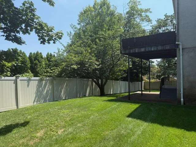 Fenced backyard with a balcony Fenced backyard with a balcony