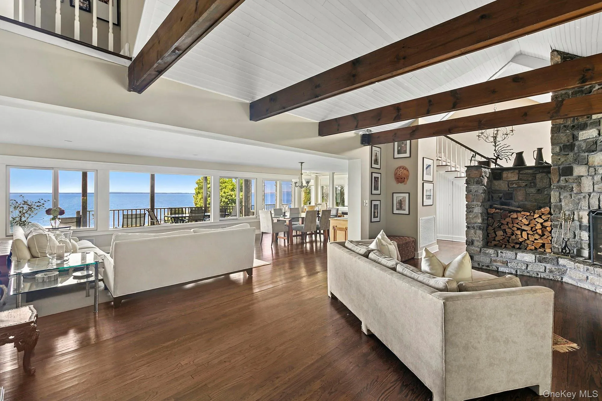 Living area with dark wood-type flooring, a water view, and a chandelier Living area with dark wood-type flooring, a water view, and a chandelier