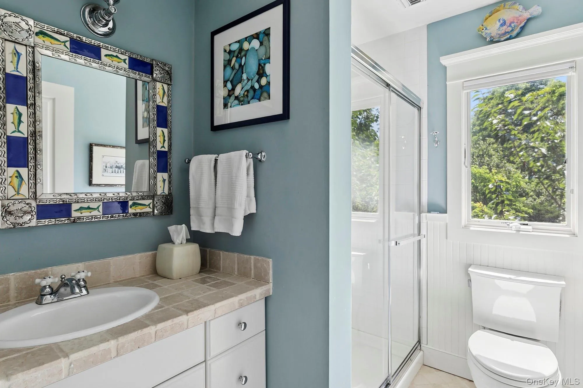 Bathroom featuring a stall shower and vanity Bathroom featuring a stall shower and vanity