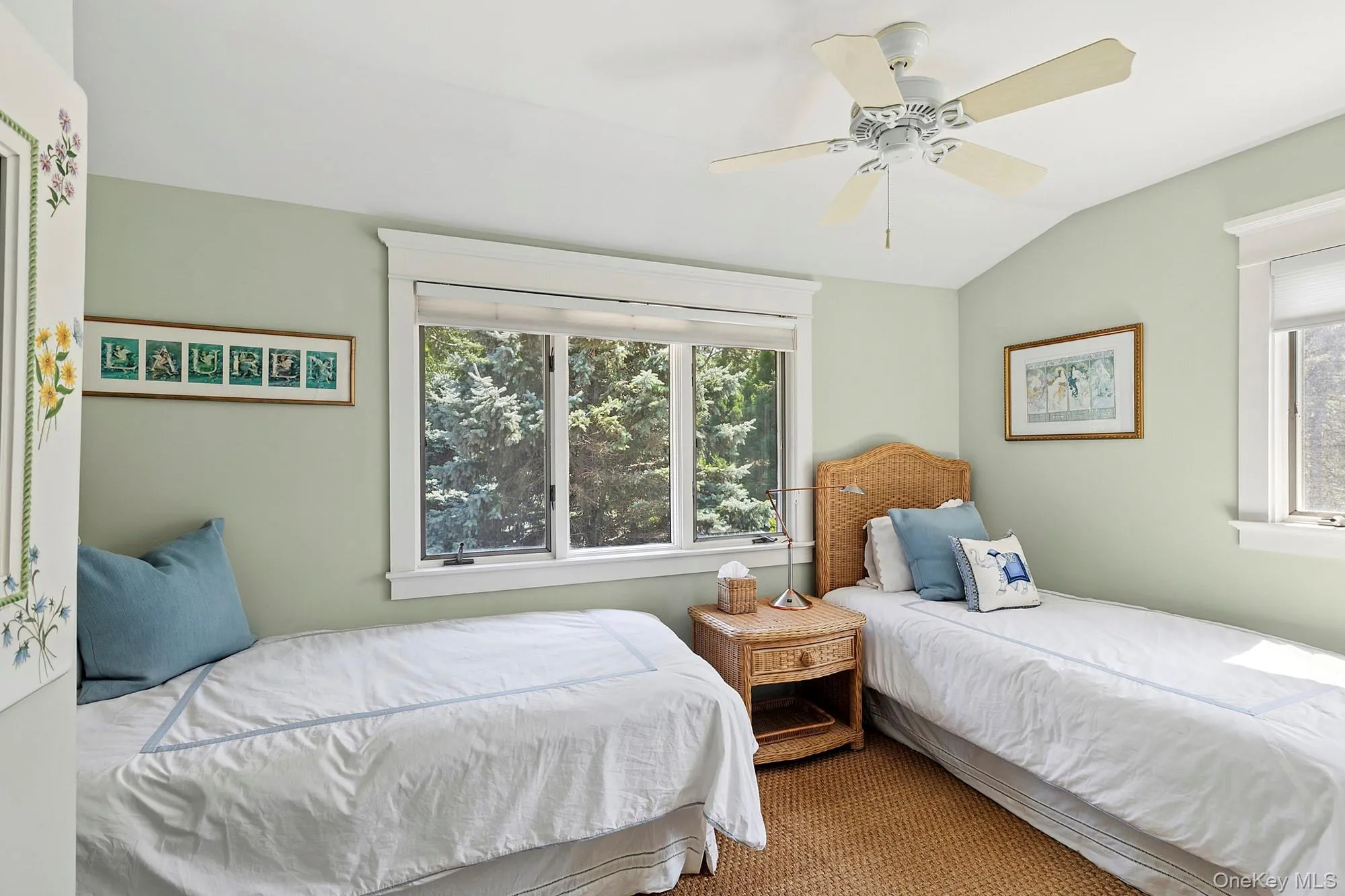 Carpeted bedroom featuring multiple windows, vaulted ceiling, and ceiling fan Carpeted bedroom featuring multiple windows, vaulted ceiling, and ceiling fan