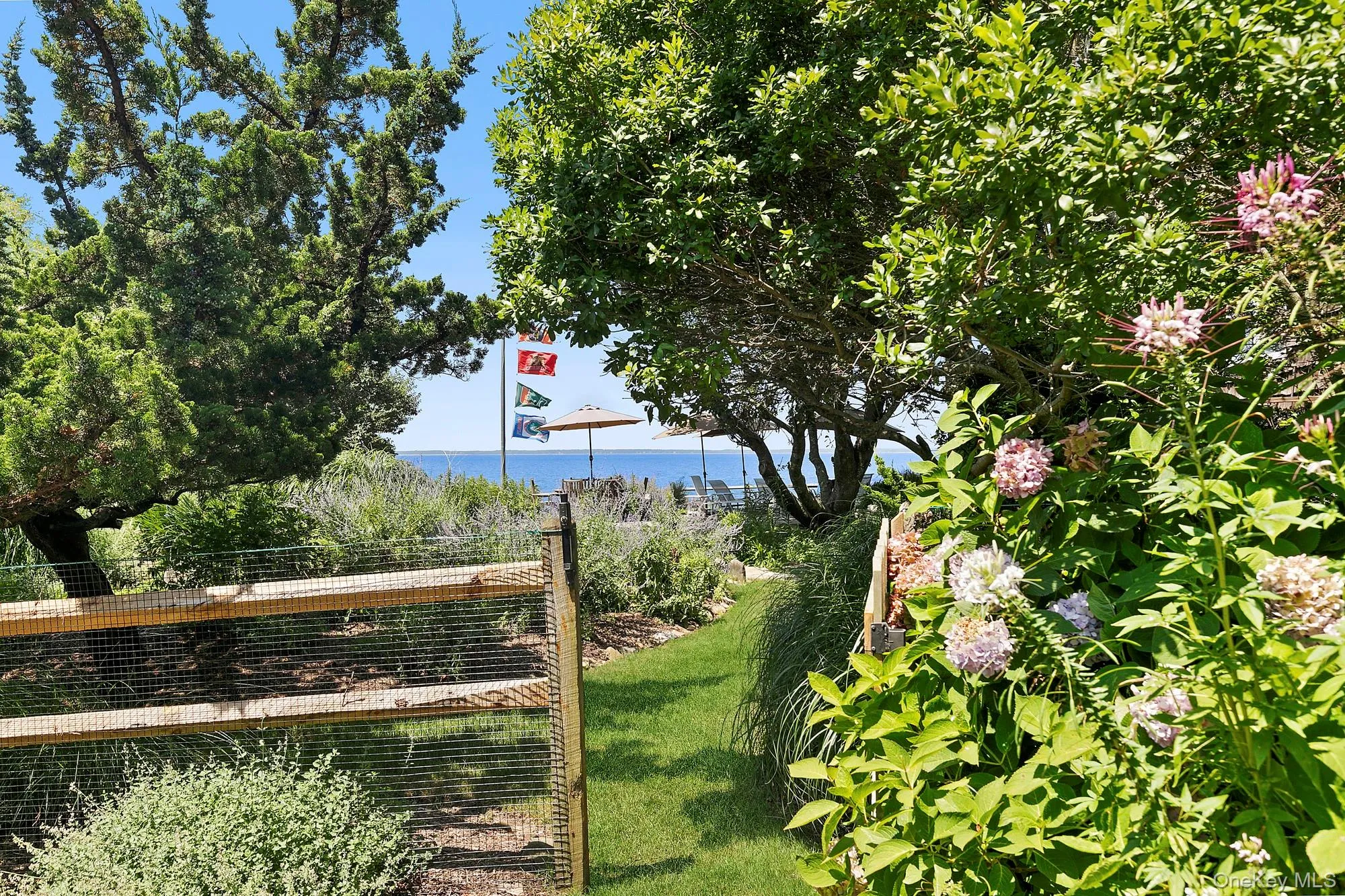 View of green lawn featuring a water view View of green lawn featuring a water view