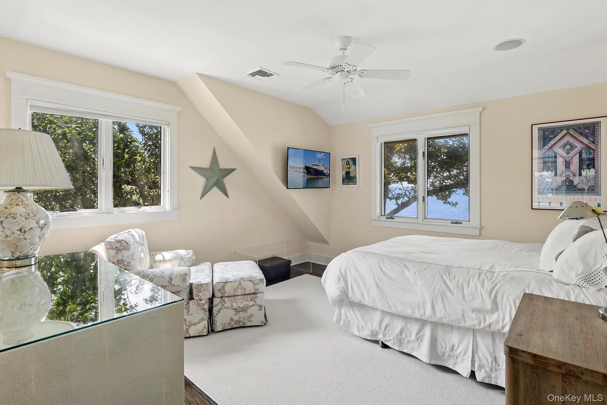 Bedroom with multiple windows, carpet flooring, a ceiling fan, and vaulted ceiling Bedroom with multiple windows, carpet flooring, a ceiling fan, and vaulted ceiling