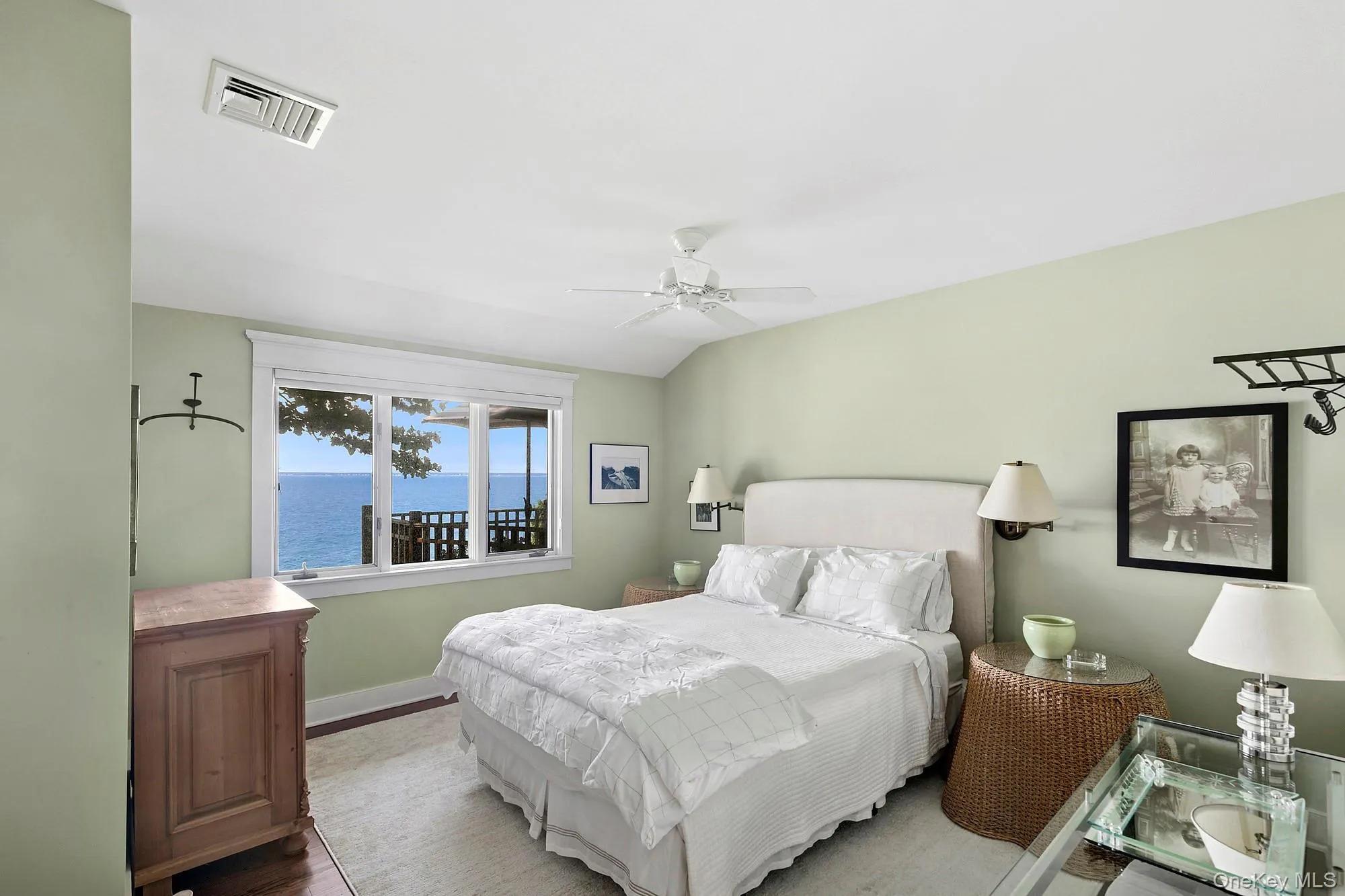 Bedroom with a water view and ceiling fan Bedroom with a water view and ceiling fan