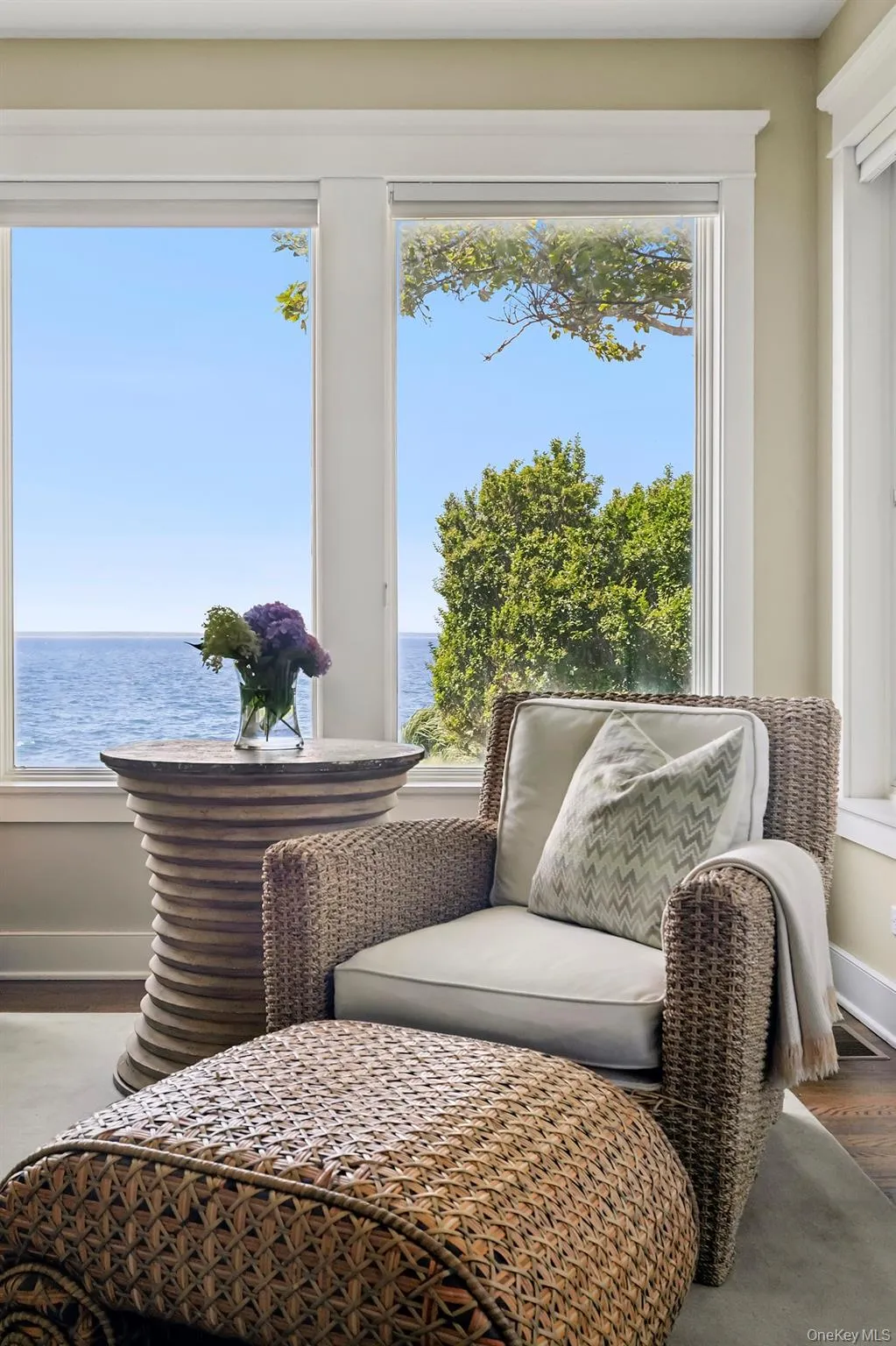 Living area featuring a water view and wood finished floors Living area featuring a water view and wood finished floors