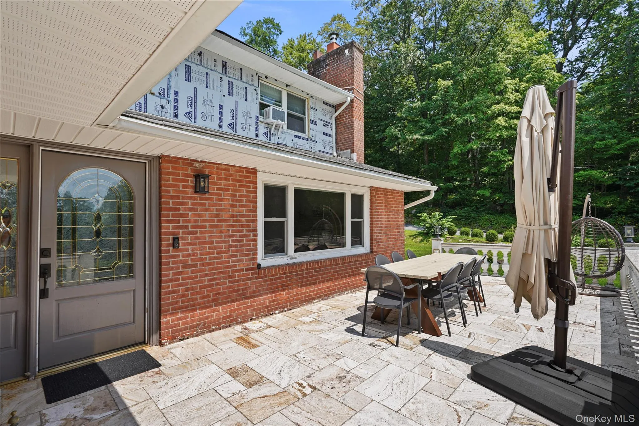 A view of the front door & outdoor dining area A view of the front door & outdoor dining area