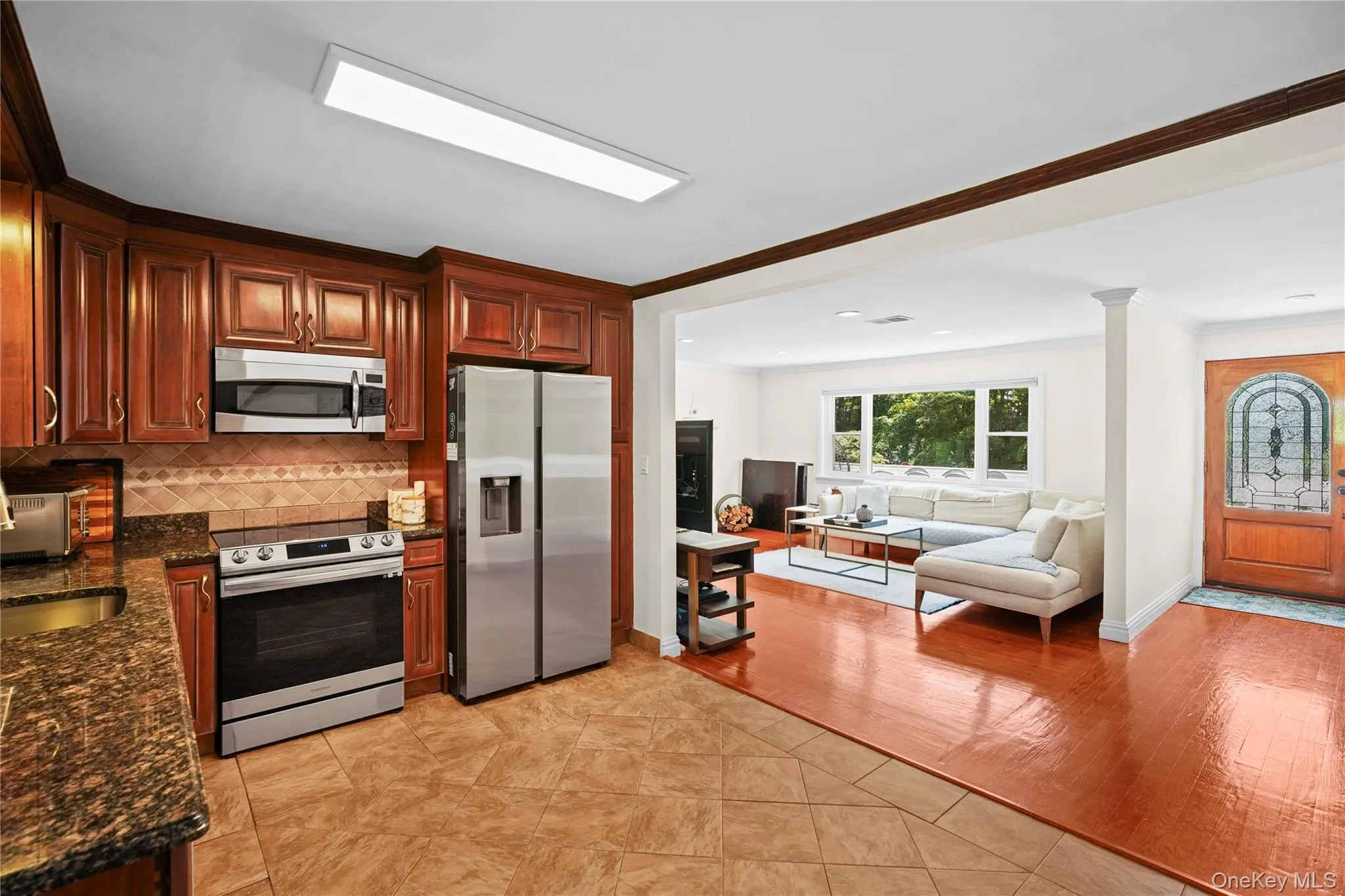 Kitchen with stainless steel appliances flows to living area Kitchen with stainless steel appliances flows to living area