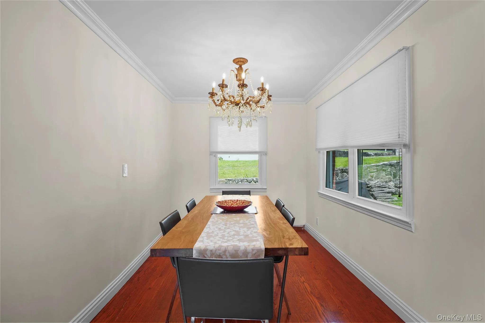 Dining area with crown molding & a chandelier Dining area with crown molding & a chandelier