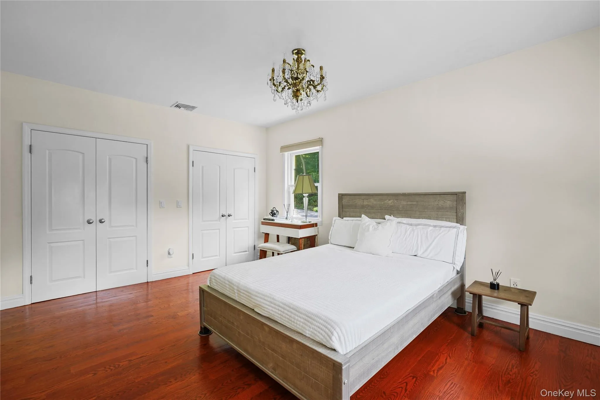 Spacious Primary Bedroom features two large closets, and a chandelier Spacious Primary Bedroom features two large closets, and a chandelier