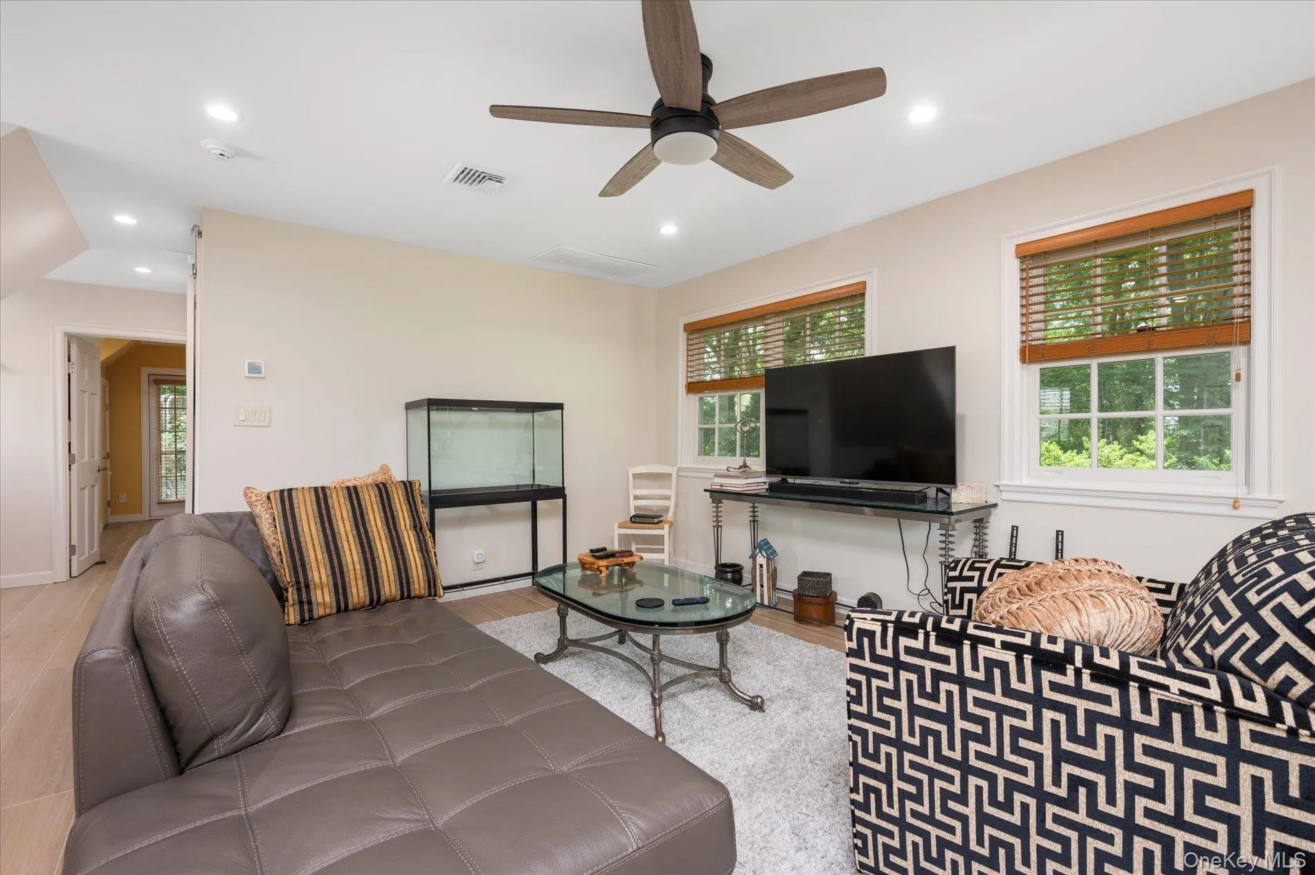 Living area featuring a ceiling fan, wood finished floors, and recessed lighting Living area featuring a ceiling fan, wood finished floors, and recessed lighting