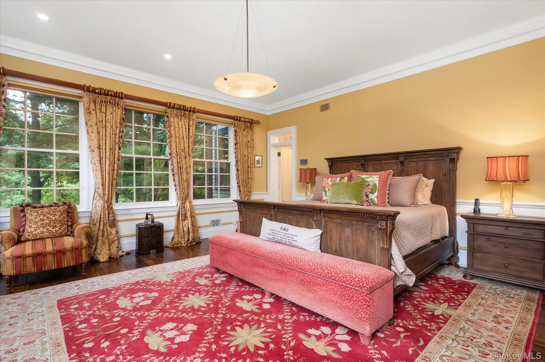 Bedroom featuring ornamental molding and wood finished floors Bedroom featuring ornamental molding and wood finished floors
