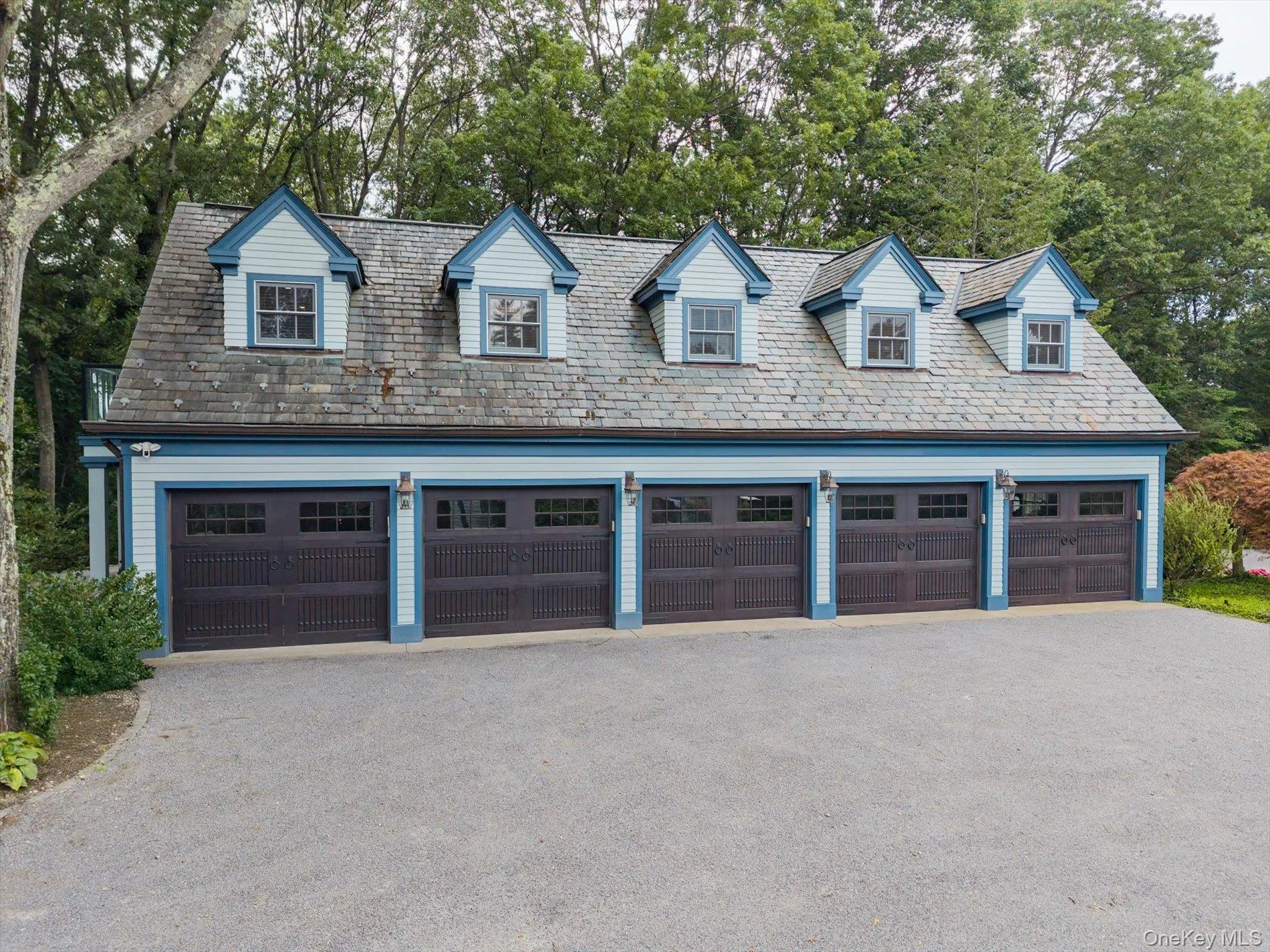Garage with view of wooded area and a detached garage Garage with view of wooded area and a detached garage