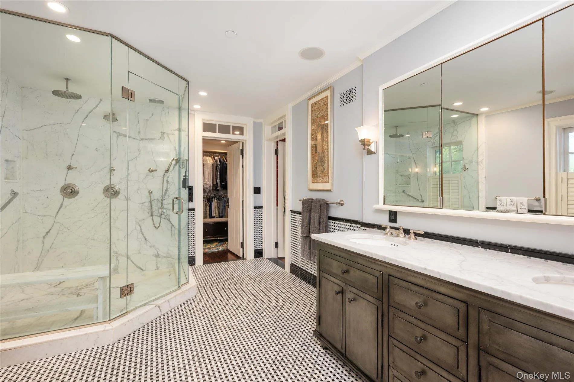Bathroom featuring a marble finish shower, crown molding, recessed lighting, vanity, and a walk in closet Bathroom featuring a marble finish shower, crown molding, recessed lighting, vanity, and a walk in closet