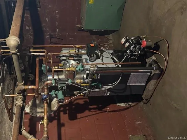 Utility room featuring a heating unit Utility room featuring a heating unit