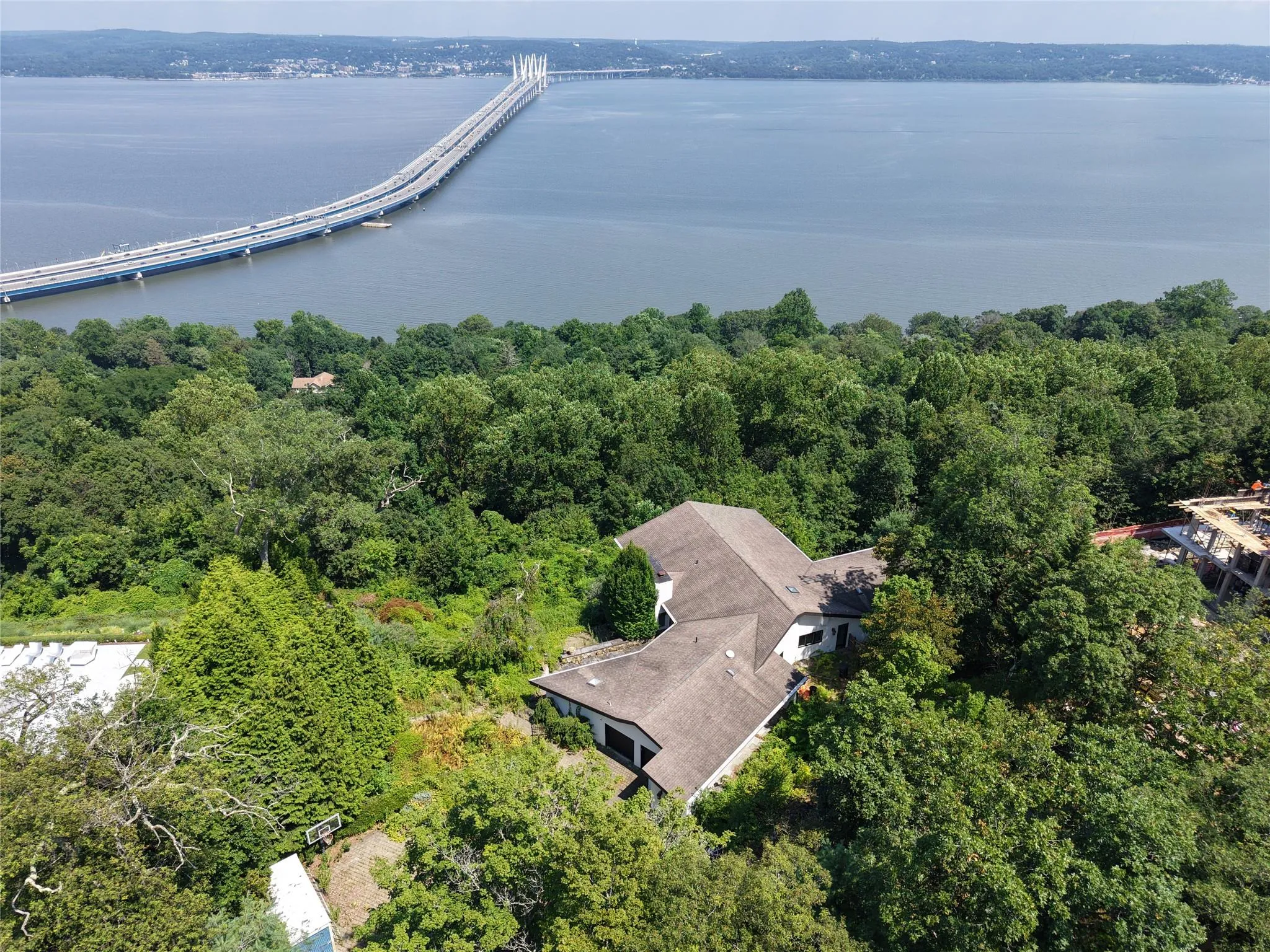 Drone / aerial view of a nearby body of water and a notable bridge Drone / aerial view of a nearby body of water and a notable bridge