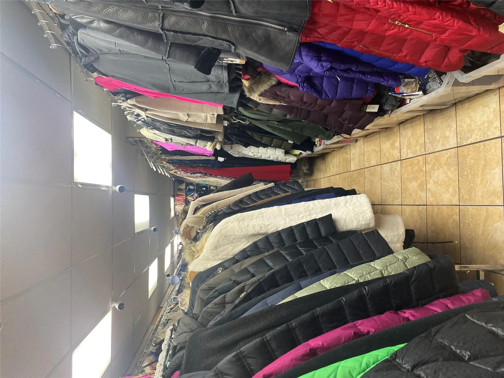 Walk in closet featuring light tile patterned floors and a paneled ceiling Walk in closet featuring light tile patterned floors and a paneled ceiling