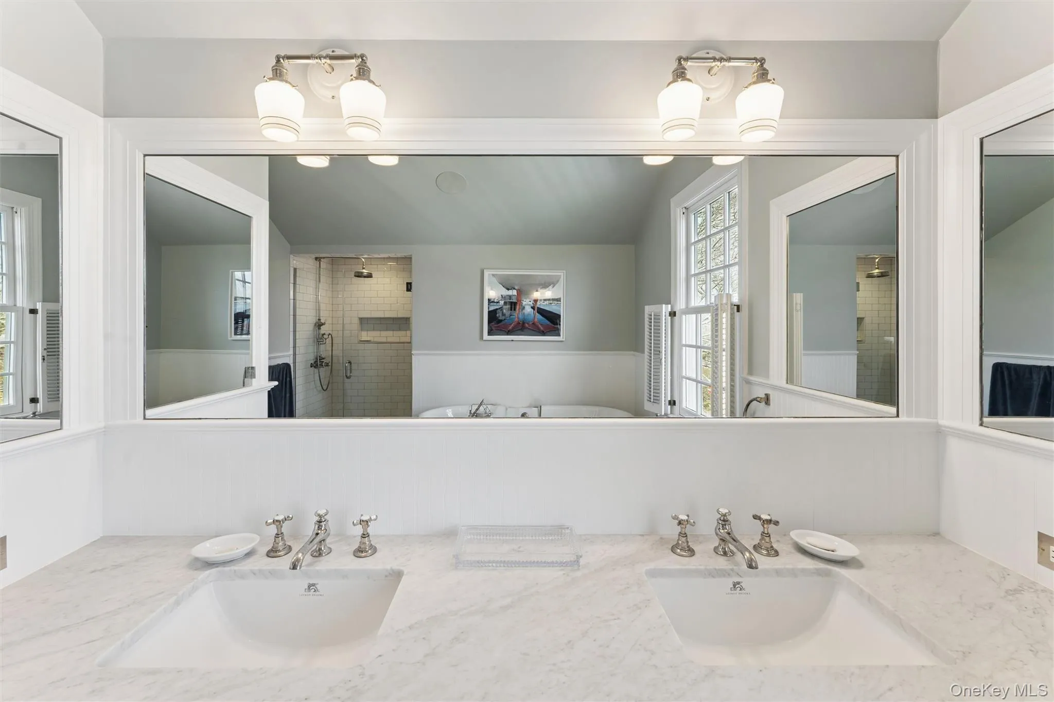 Full bathroom with double vanity, a stall shower, and a sink Full bathroom with double vanity, a stall shower, and a sink