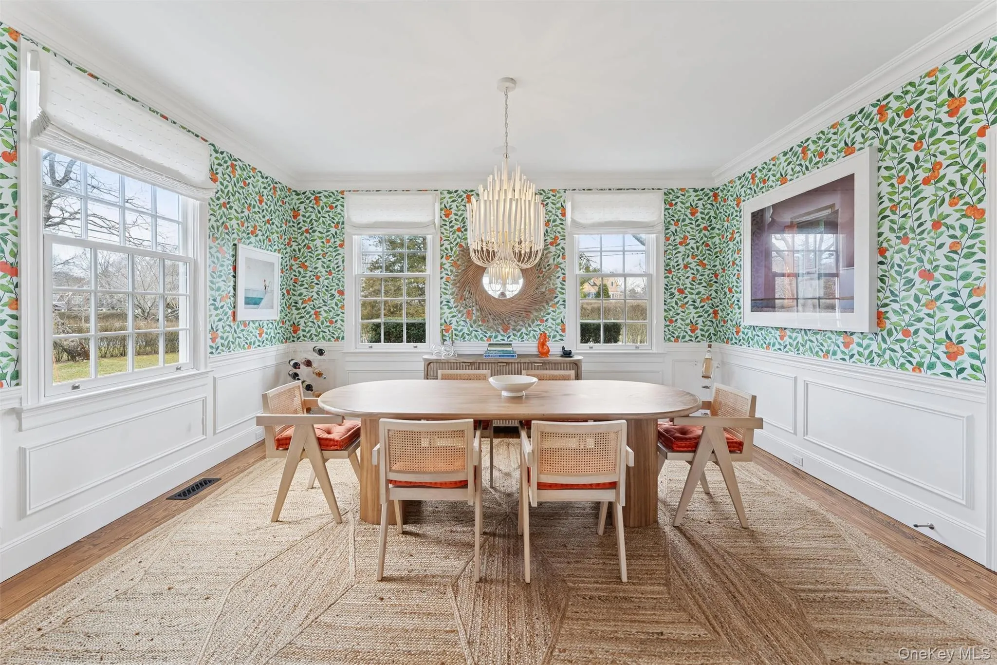 Dining room featuring wallpapered walls, a wainscoted wall, plenty of natural light, and visible vents Dining room featuring wallpapered walls, a wainscoted wall, plenty of natural light, and visible vents