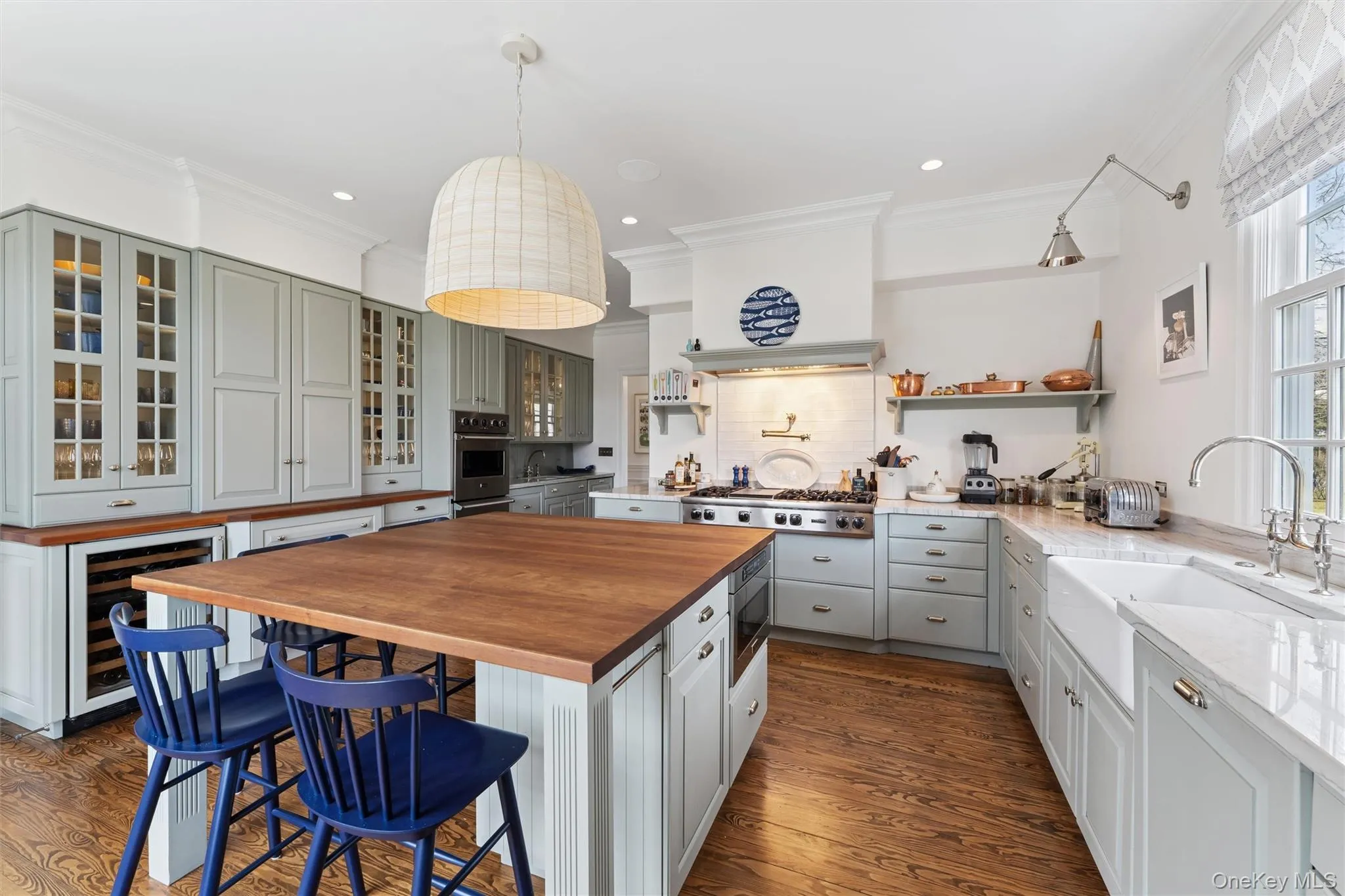 Kitchen featuring wine cooler, gray cabinets, stainless steel appliances, wood counters, and a sink Kitchen featuring wine cooler, gray cabinets, stainless steel appliances, wood counters, and a sink