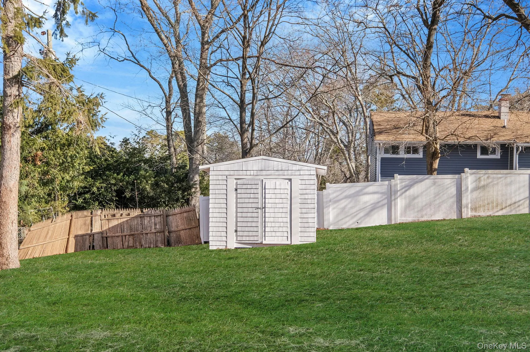 Fenced backyard featuring a shed Fenced backyard featuring a shed