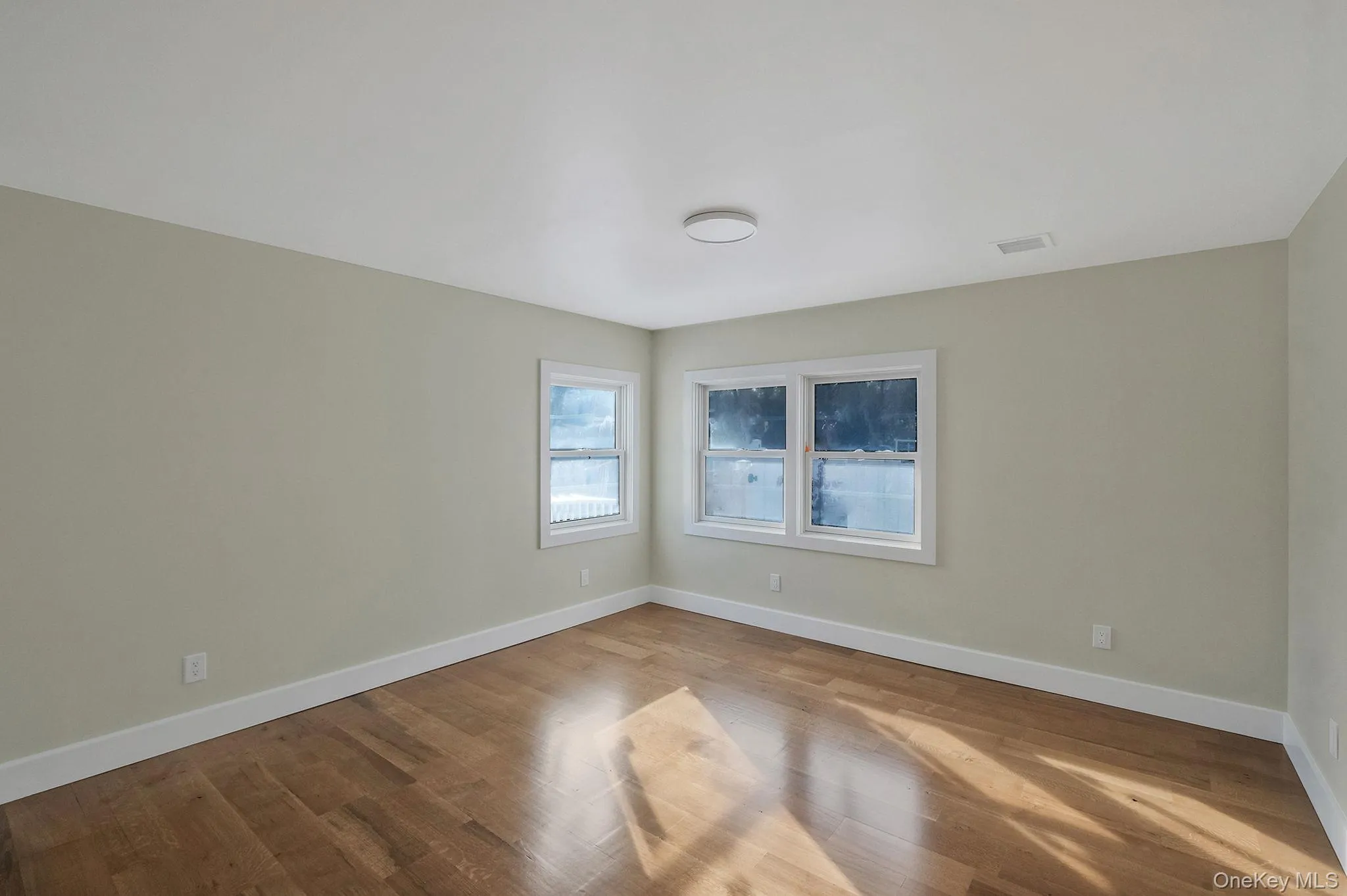 Empty room featuring baseboards and wood finished floors Empty room featuring baseboards and wood finished floors