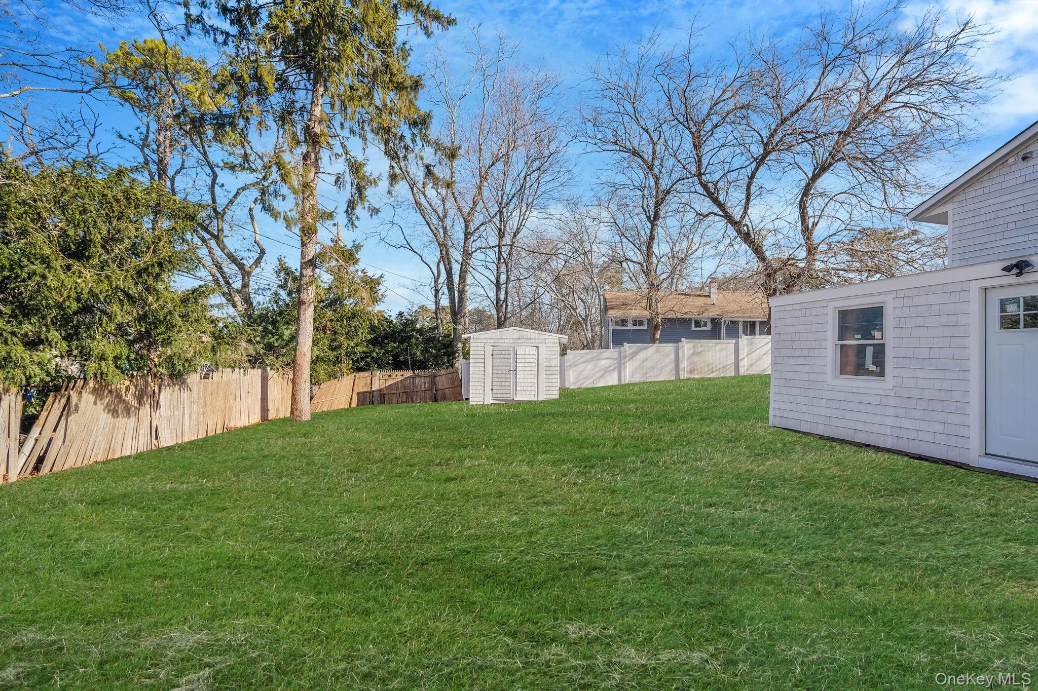 Fenced backyard featuring a storage shed Fenced backyard featuring a storage shed