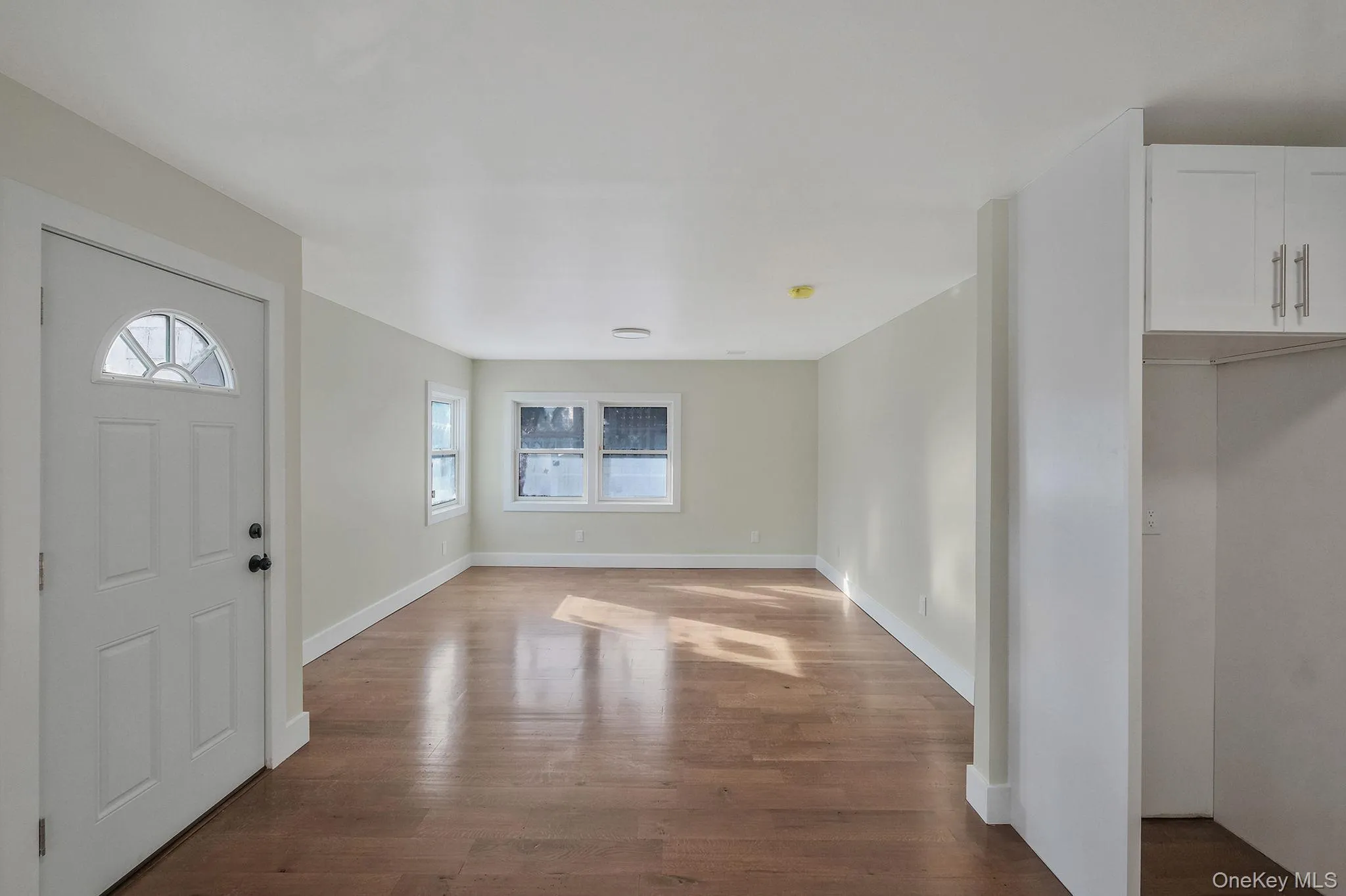 Foyer entrance featuring wood finished floors and baseboards Foyer entrance featuring wood finished floors and baseboards