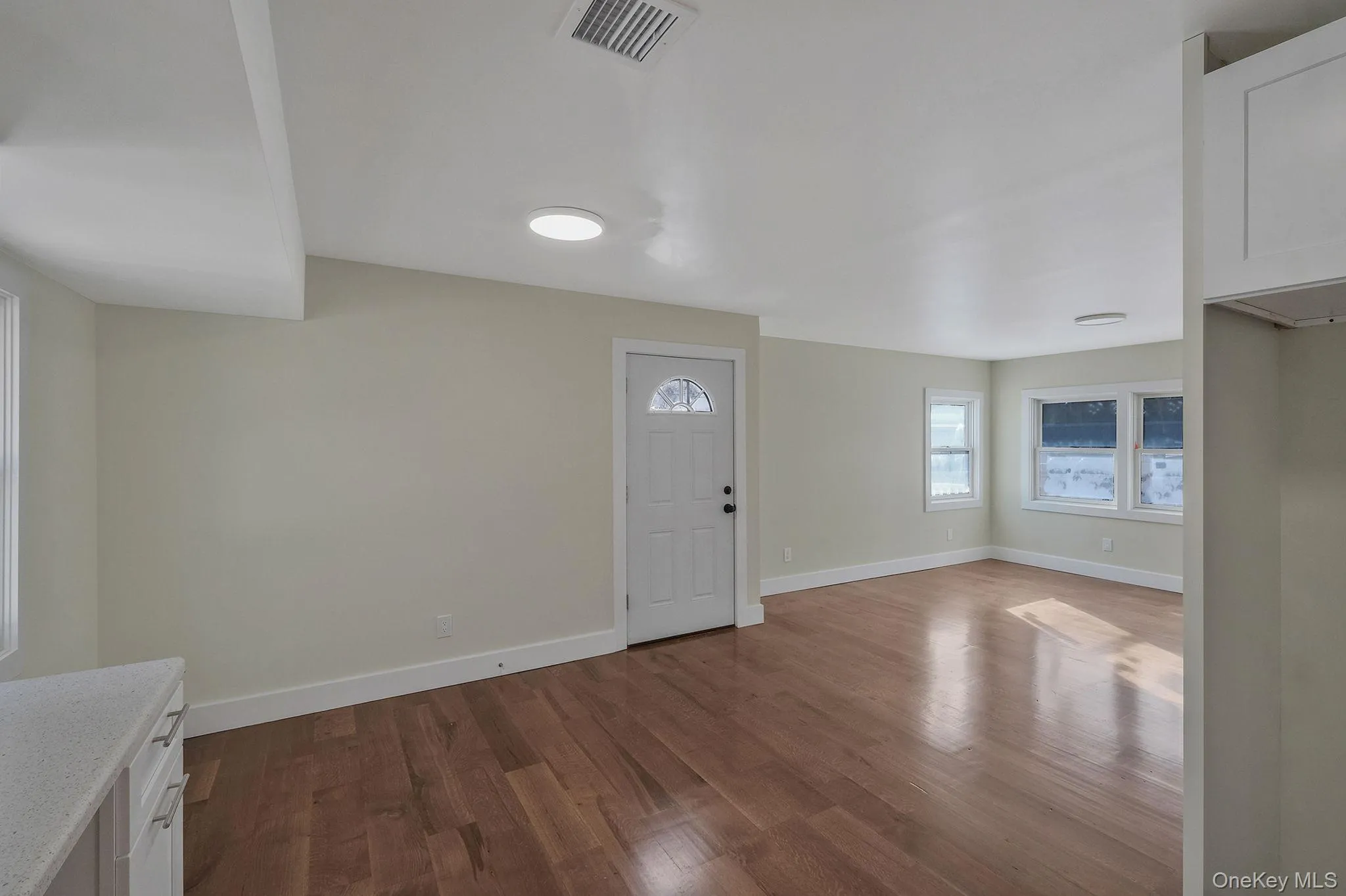 Entrance foyer featuring dark wood finished floors and baseboards Entrance foyer featuring dark wood finished floors and baseboards