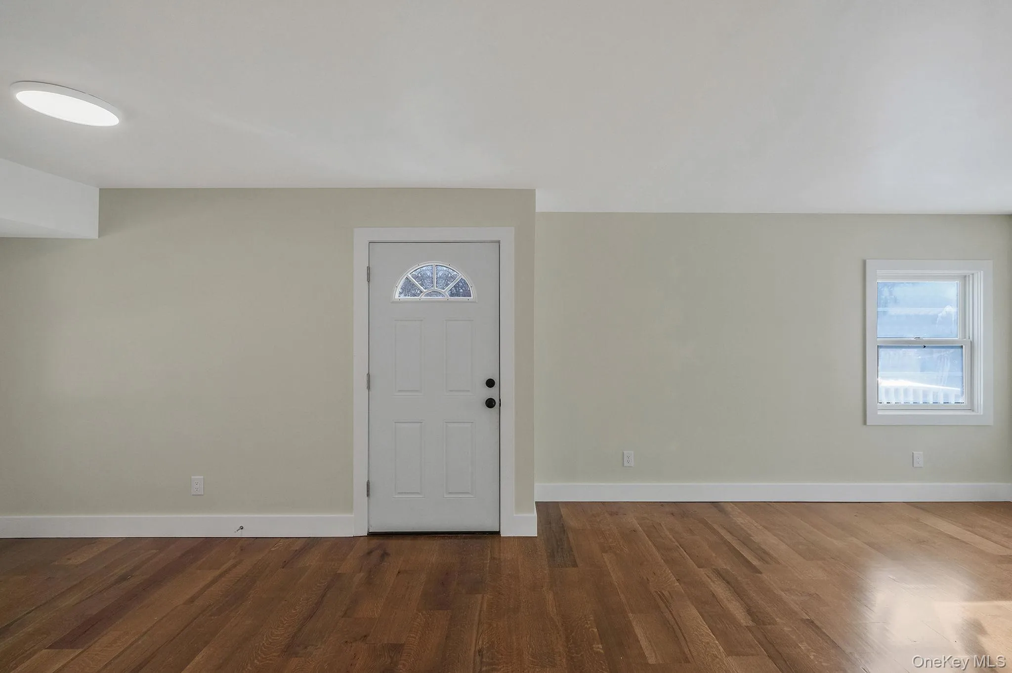 Entrance foyer with wood finished floors and baseboards Entrance foyer with wood finished floors and baseboards