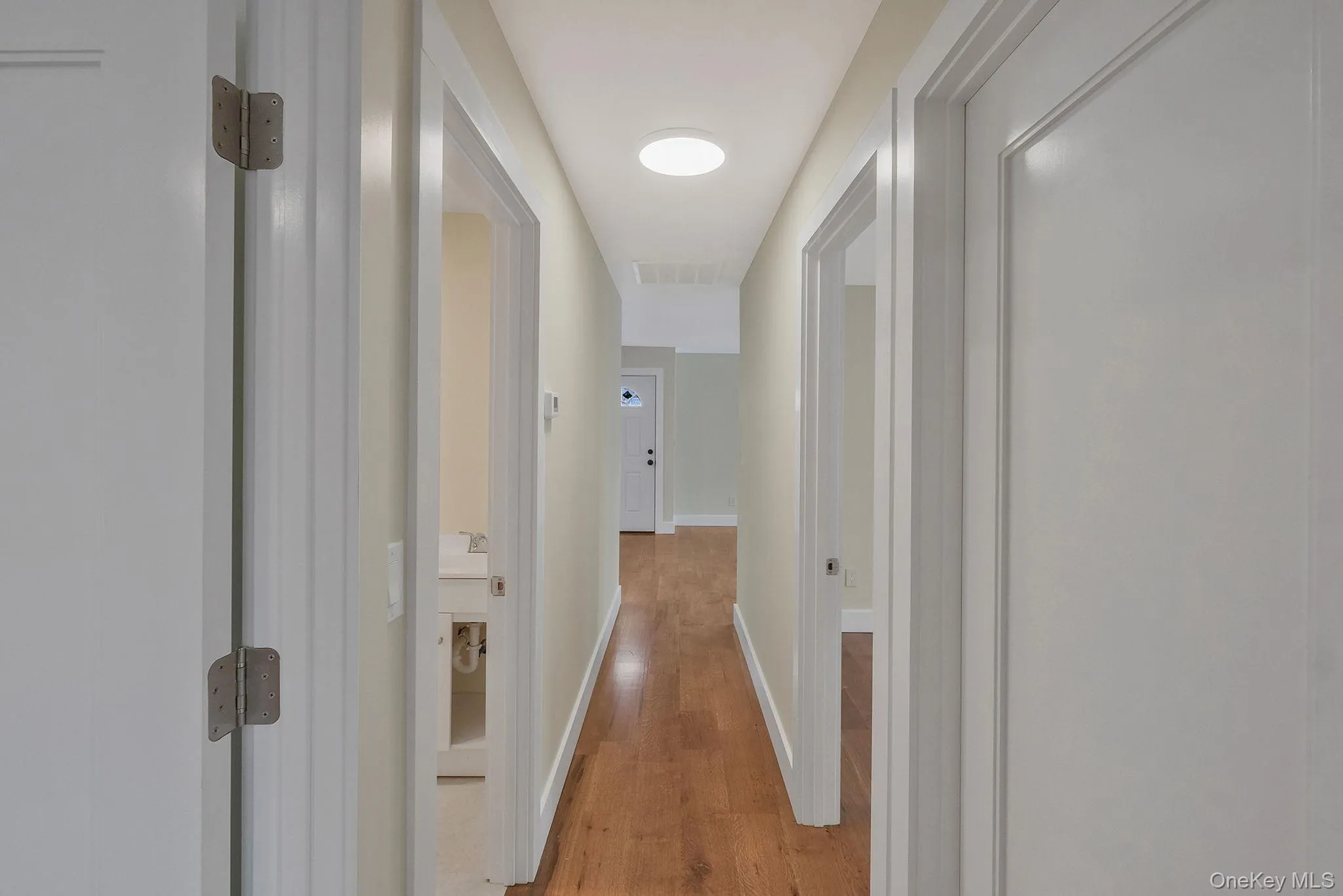 Corridor with light wood-type flooring and baseboards Corridor with light wood-type flooring and baseboards