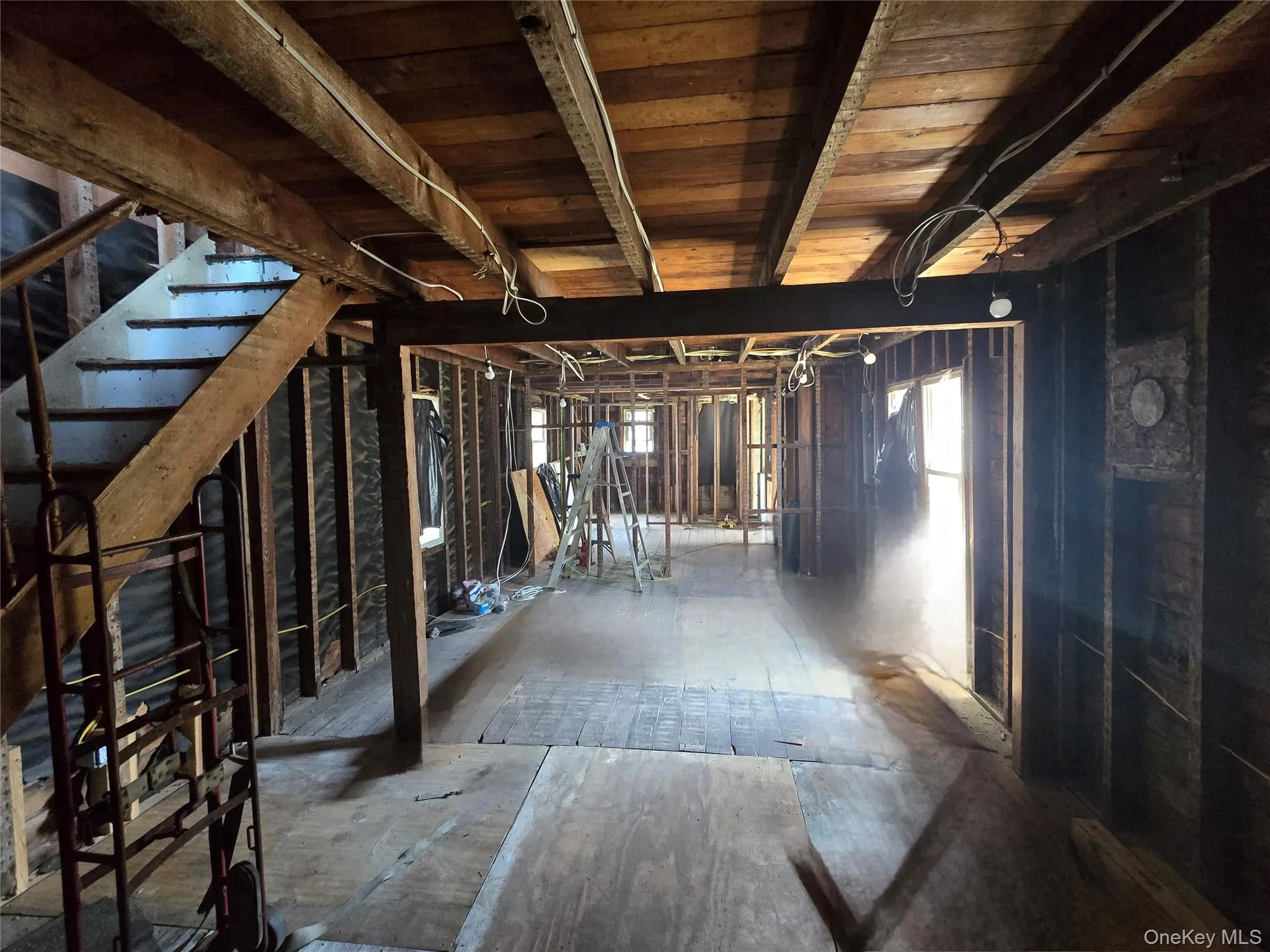 Below grade area featuring plenty of natural light and stairs Below grade area featuring plenty of natural light and stairs