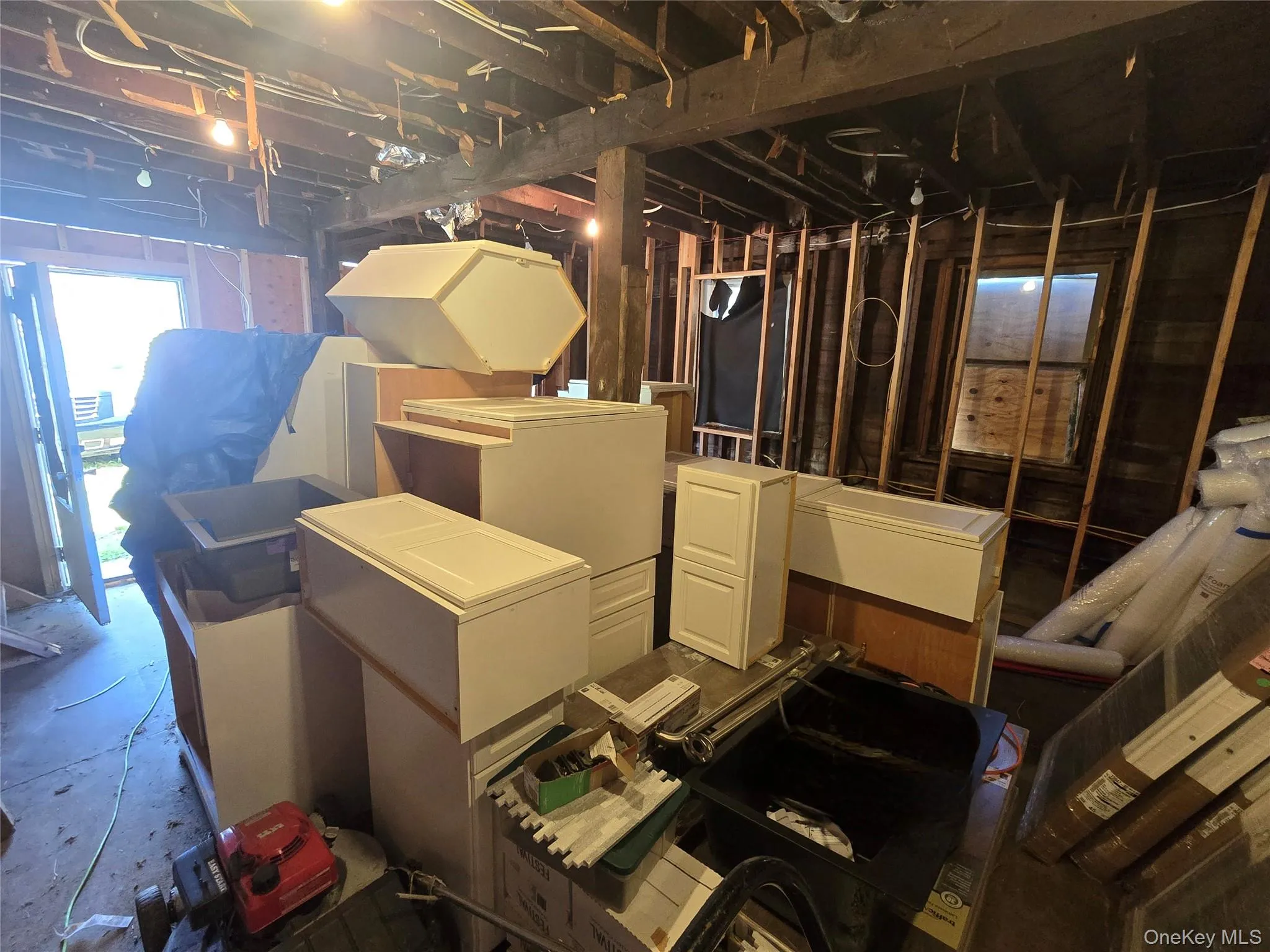 Below grade area featuring fridge Below grade area featuring fridge