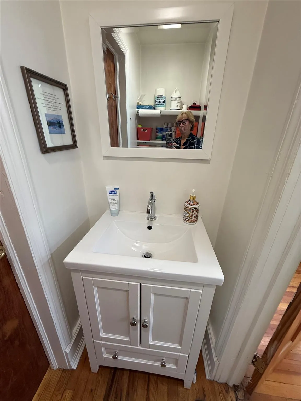 Shared bathroom featuring vanity and wood finished floors Shared bathroom featuring vanity and wood finished floors