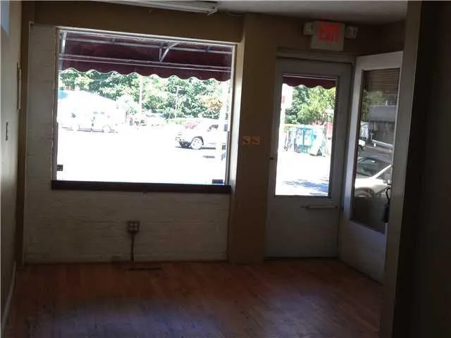 Unit A: Retail/Office space with wood finished floors and large windows Unit A: Retail/Office space with wood finished floors and large windows