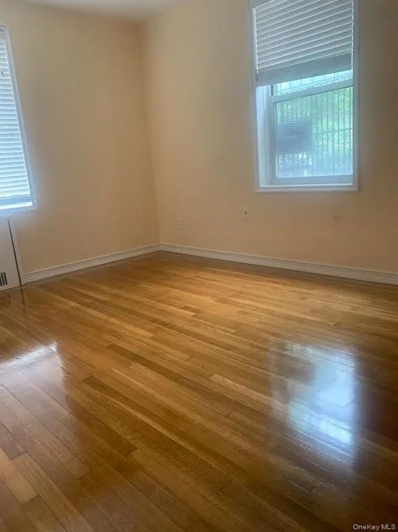 Empty room with wood finished floors and baseboards Empty room with wood finished floors and baseboards