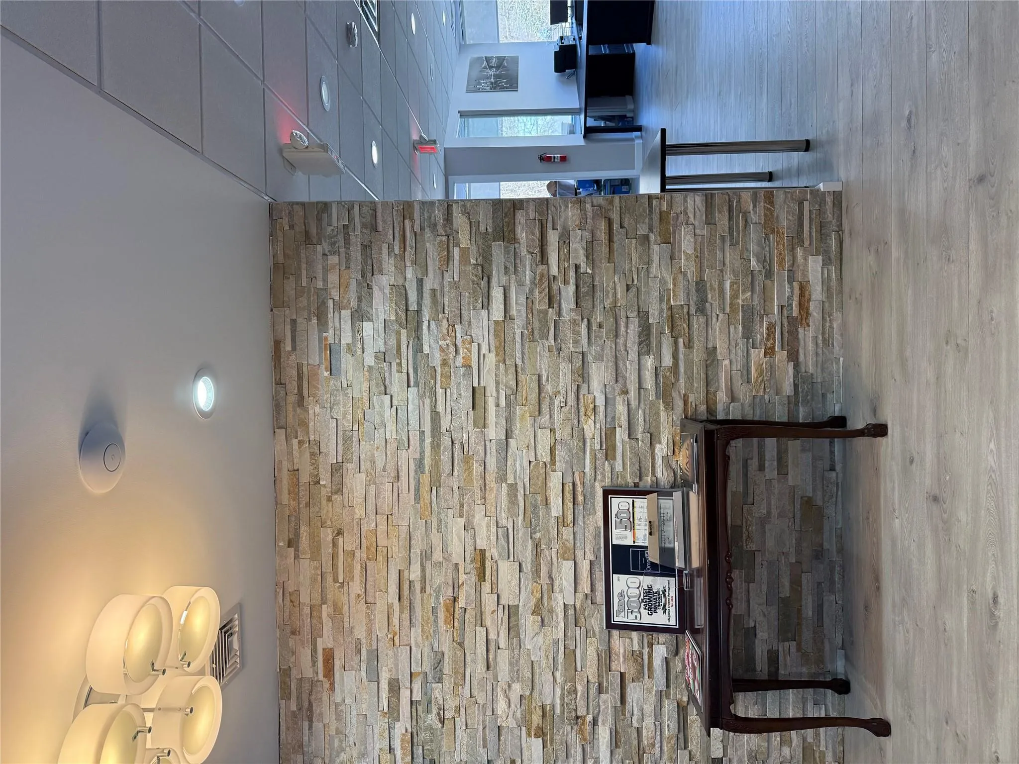 Hallway featuring wood finished floors and recessed lighting Hallway featuring wood finished floors and recessed lighting