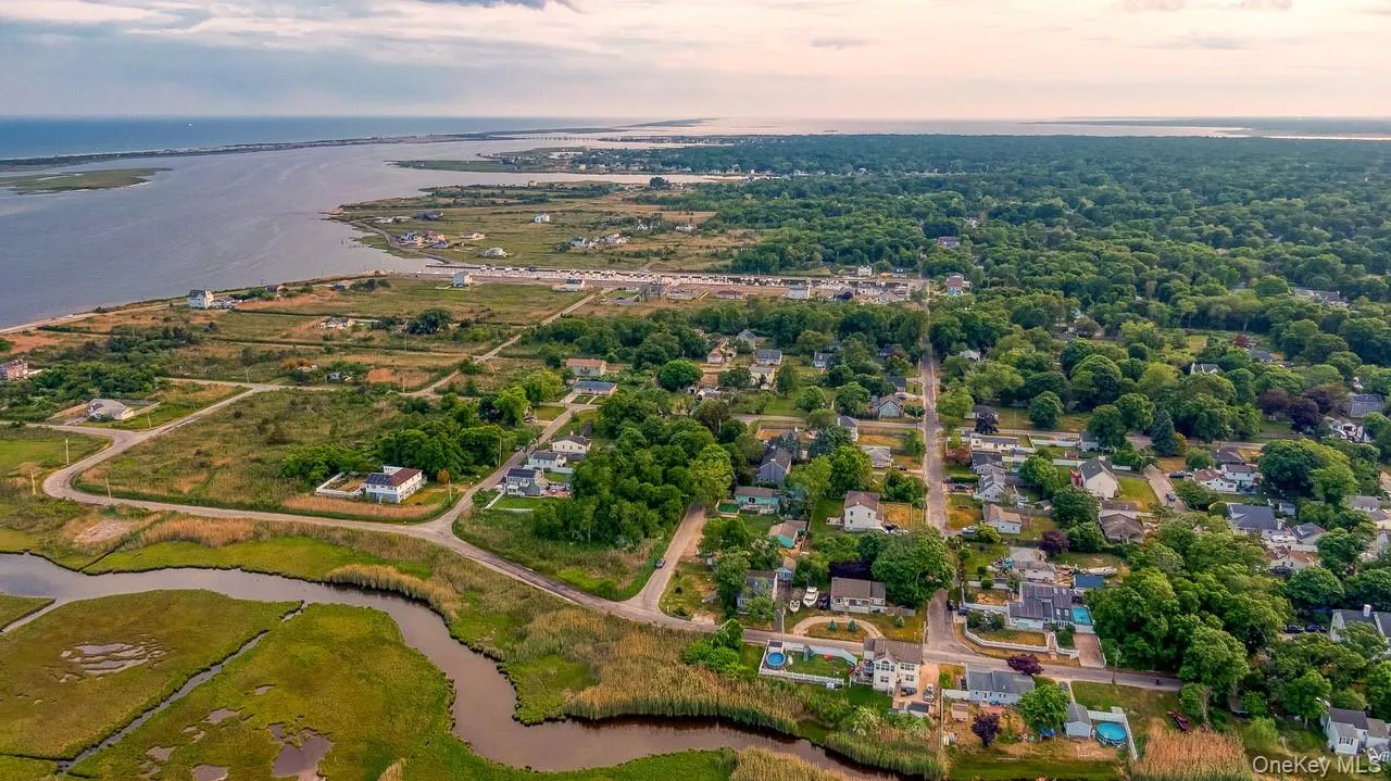 Aerial perspective of suburban area featuring a large body of water Aerial perspective of suburban area featuring a large body of water