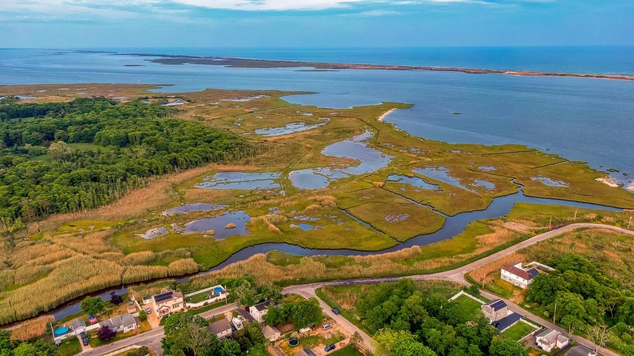 Aerial view of property and surrounding area featuring a large body of water Aerial view of property and surrounding area featuring a large body of water