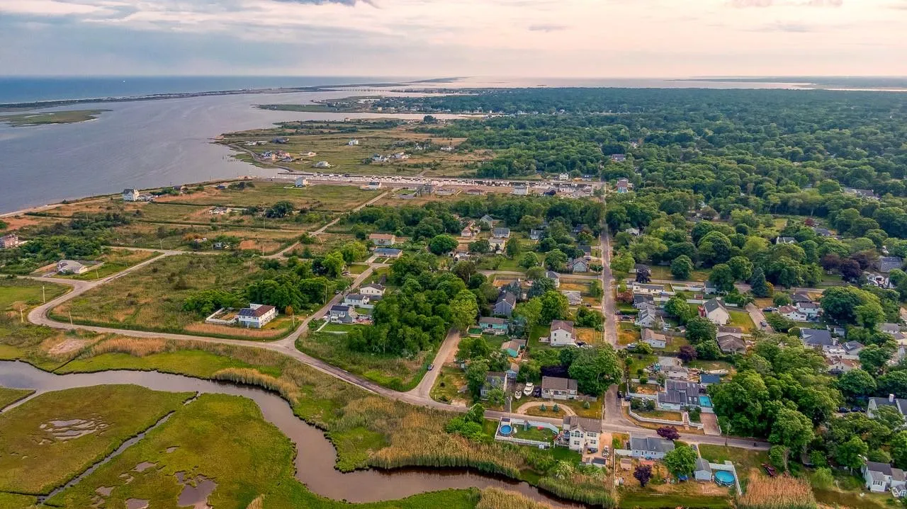 Aerial perspective of suburban area featuring a large body of water Aerial perspective of suburban area featuring a large body of water