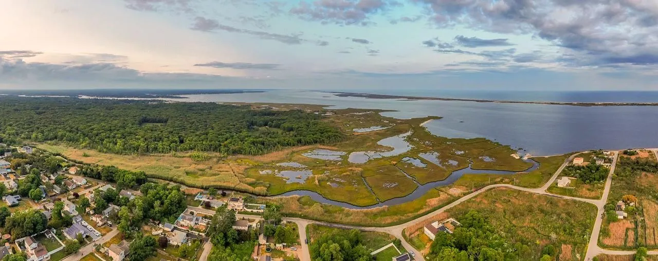 Aerial view of property and surrounding area featuring a nearby body of water Aerial view of property and surrounding area featuring a nearby body of water
