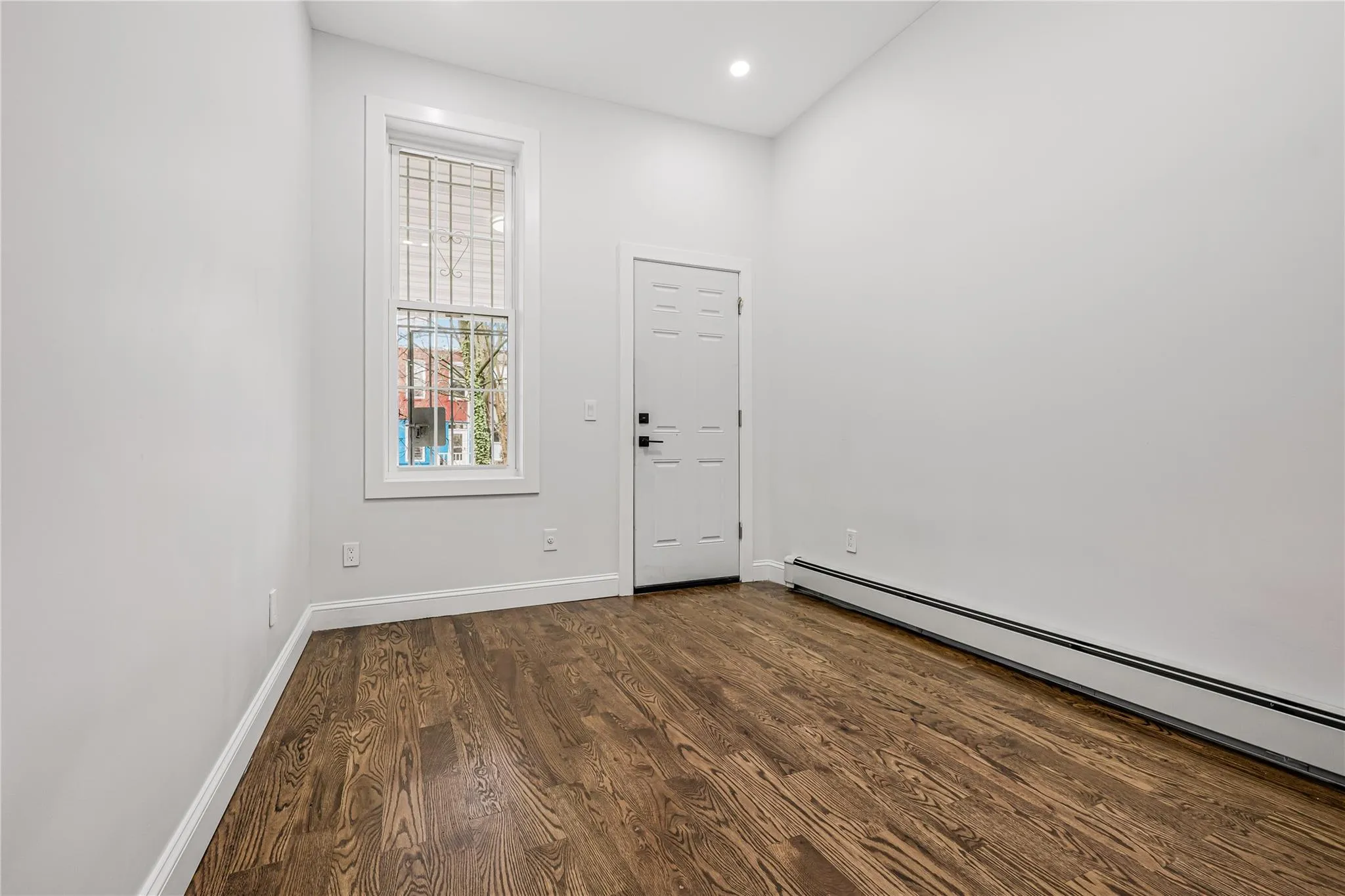 Entryway with baseboard heating, dark wood finished floors, and recessed lighting Entryway with baseboard heating, dark wood finished floors, and recessed lighting