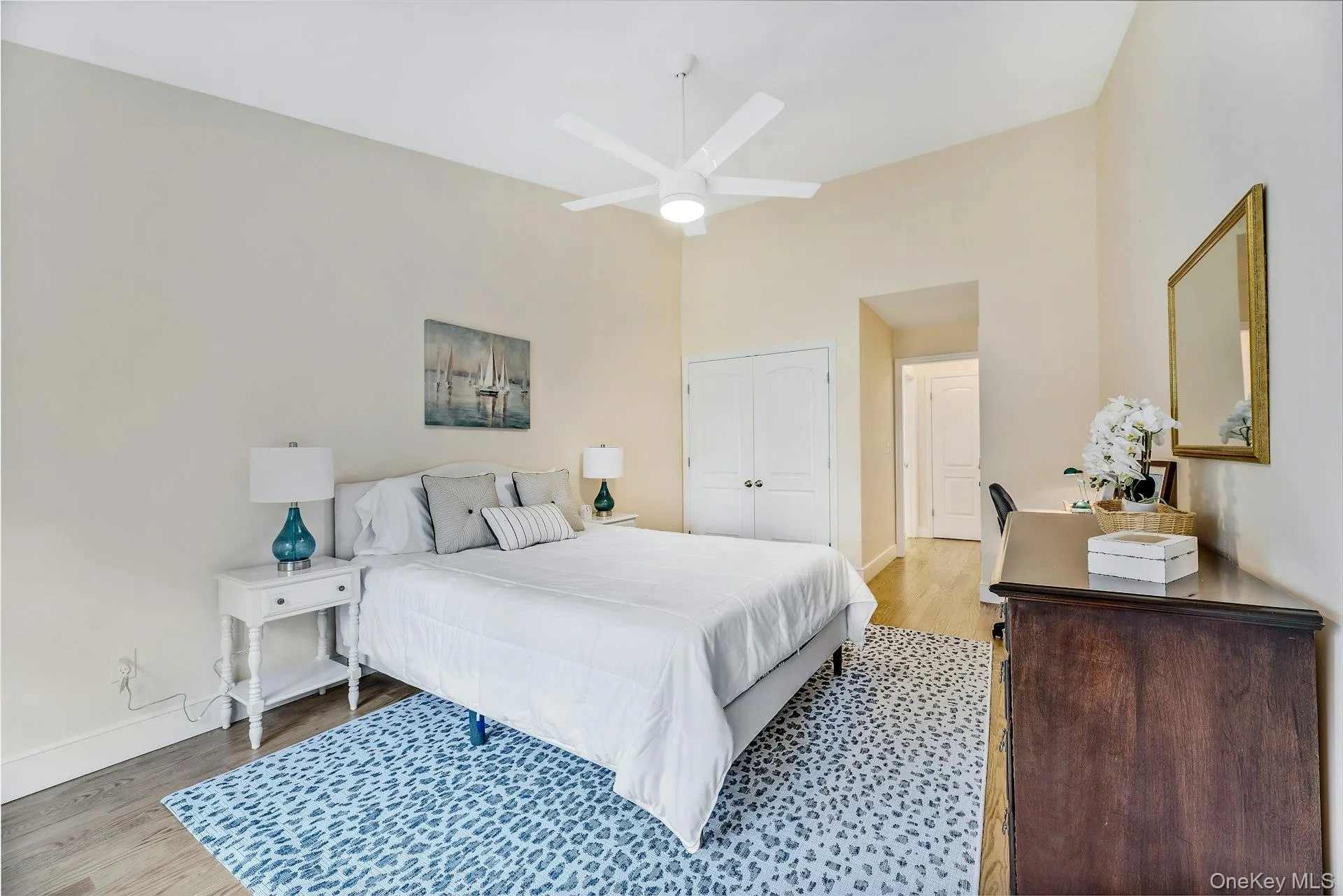 Bedroom with wood finished floors, ceiling fan, and a closet Bedroom with wood finished floors, ceiling fan, and a closet