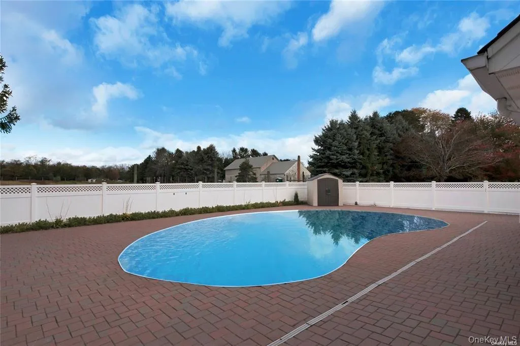 View of swimming pool with a storage unit, a fenced backyard, and a patio area View of swimming pool with a storage unit, a fenced backyard, and a patio area