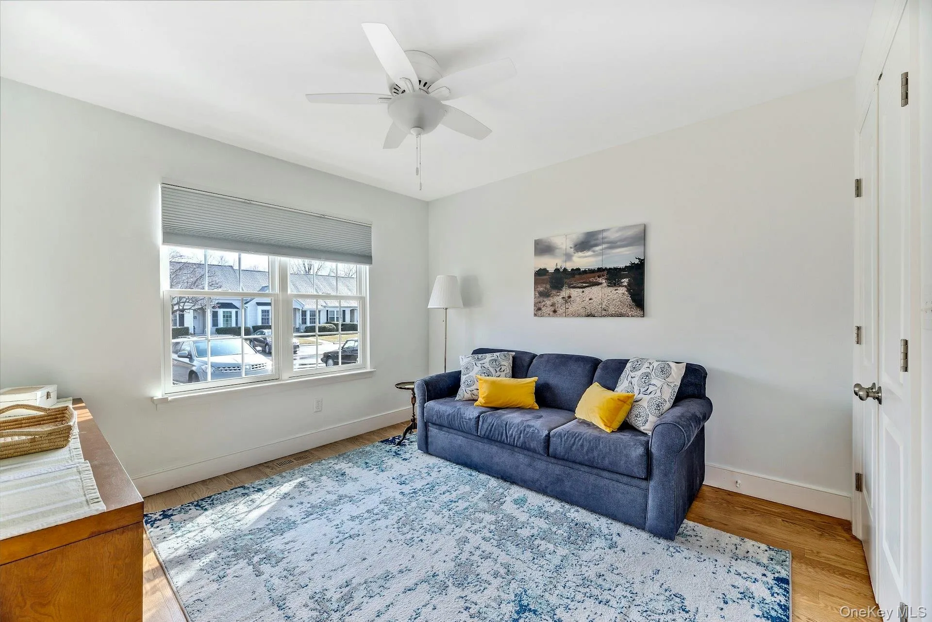 Living room featuring light wood-type flooring and ceiling fan Living room featuring light wood-type flooring and ceiling fan