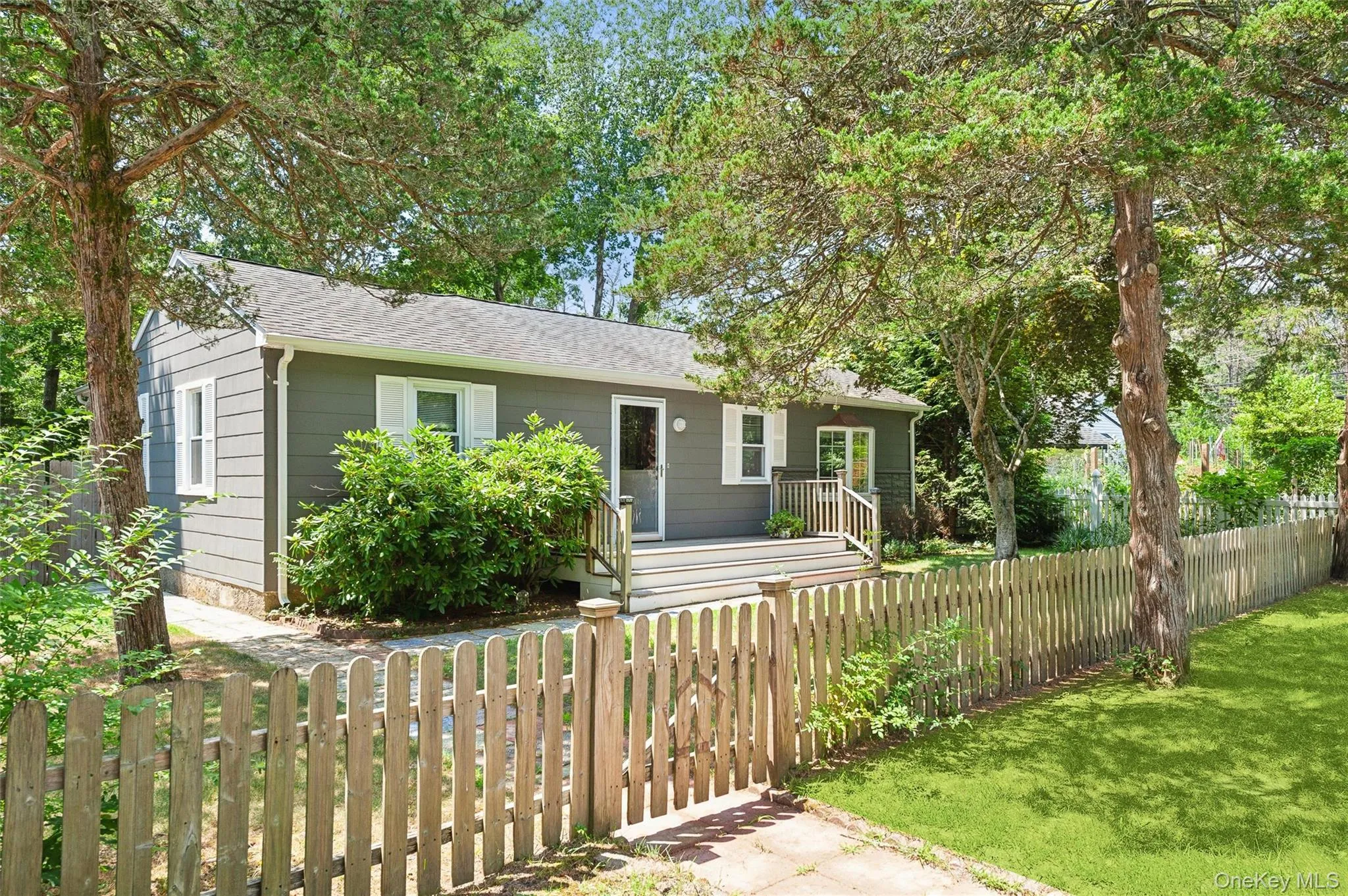 View of front of home featuring a fenced front yard and roof with shingles View of front of home featuring a fenced front yard and roof with shingles