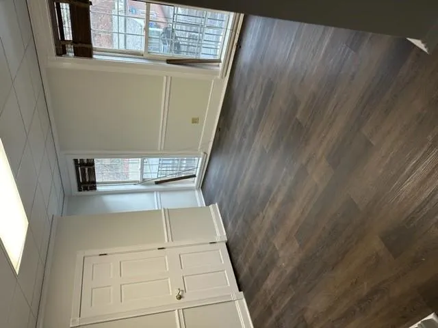 Spare room featuring dark wood finished floors and a paneled ceiling Spare room featuring dark wood finished floors and a paneled ceiling