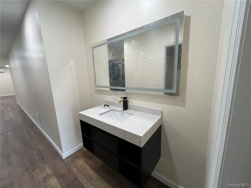 Vanity and sink is situated outside the bathroom. Vanity and sink is situated outside the bathroom.