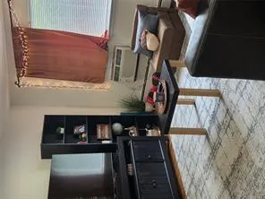 Living room featuring brick flooring and cooling unit Living room featuring brick flooring and cooling unit