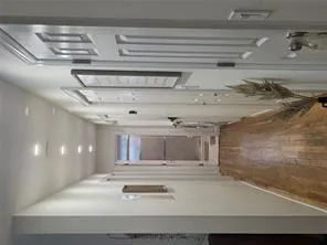 Hallway featuring dark wood-style floors and baseboards Hallway featuring dark wood-style floors and baseboards